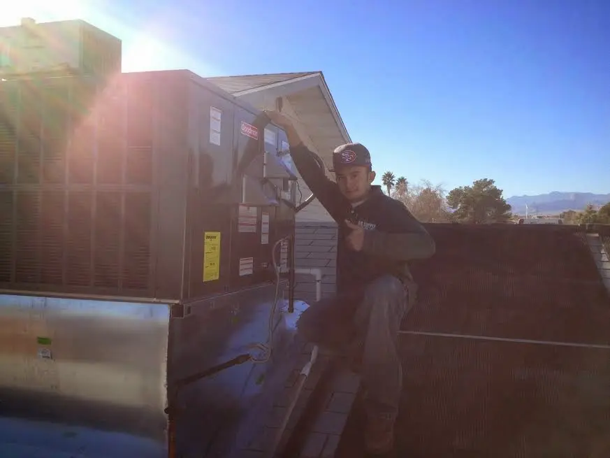 HVAC technician performing HVAC Inspection on a rooftop unit in Jamul